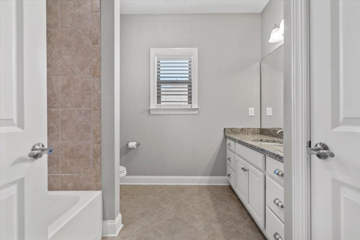 8131 Clems Branch Road Indian Land, SC 29707 - Photo 36 of 47 a bathroom with a granite countertop sink a mirror and a bathtub
