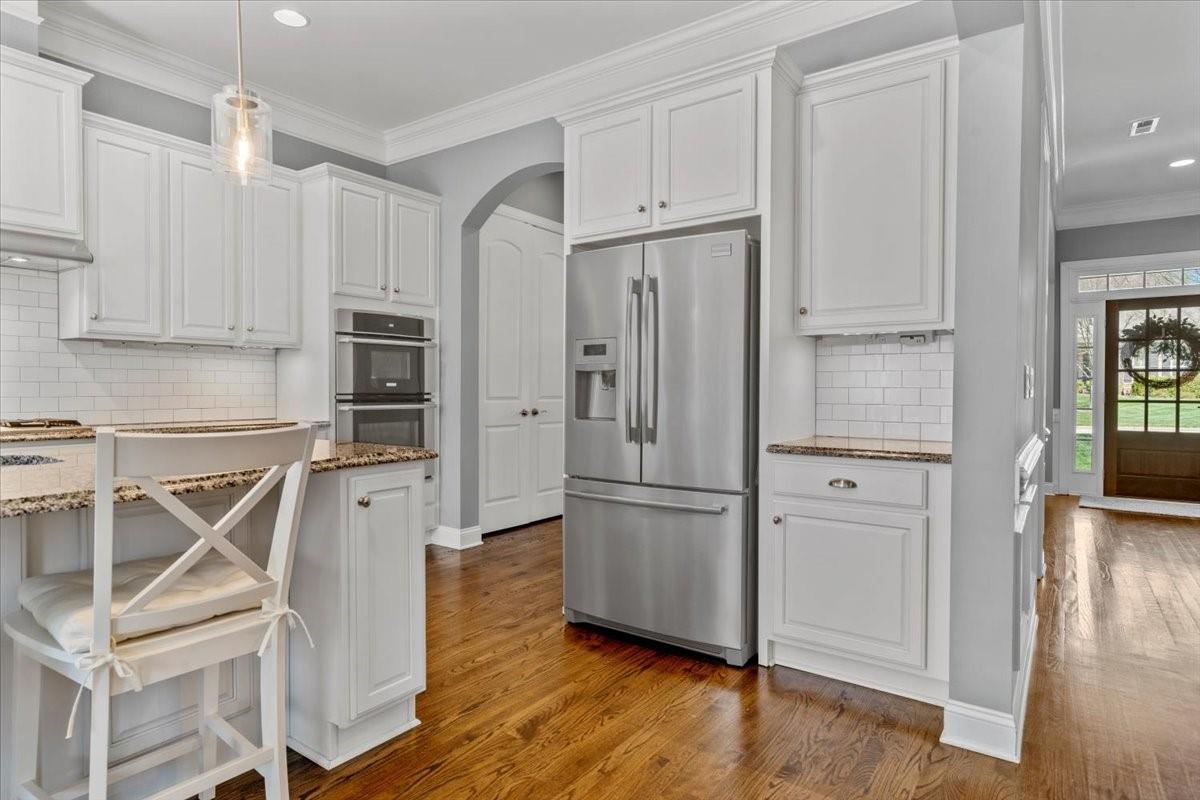 8131 Clems Branch Road Indian Land, SC 29707 - Photo 10 of 47 a kitchen with stainless steel appliances wooden floor and cabinets