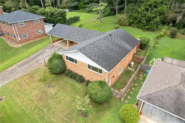 an aerial view of a house with a garden and swimming pool