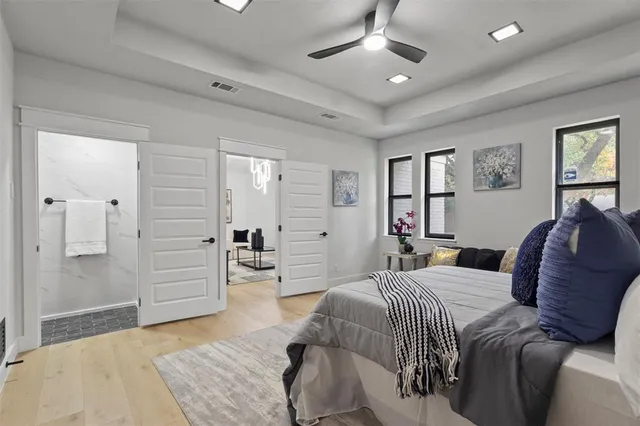 a spacious bedroom with a bed and a walk in closet