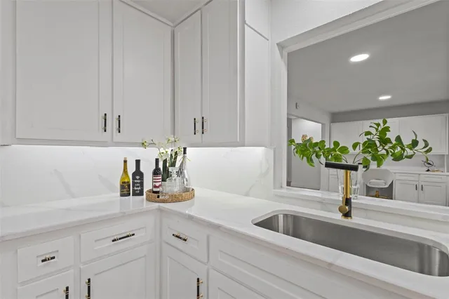 a kitchen with a sink and cabinets
