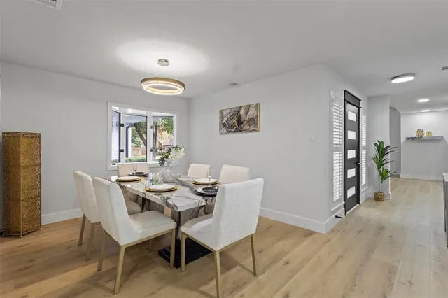 a dining room with furniture and wooden floor