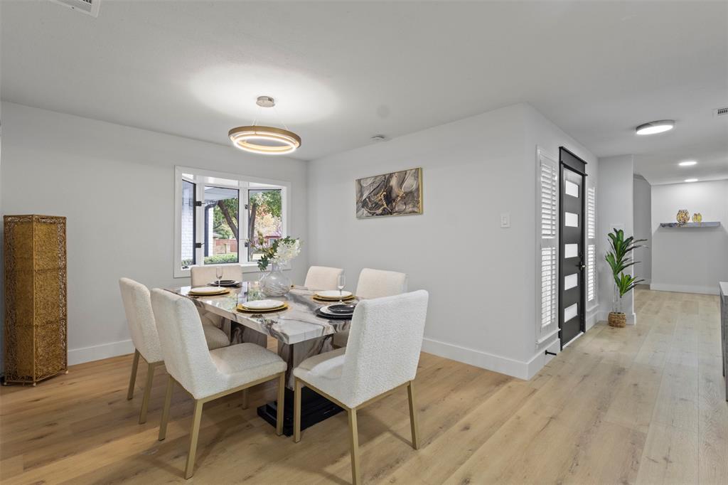 1 Spring Valley Court Richardson, TX 75081 - Photo 21 of 40 Dining area featuring baseboards and LVP wood-style flooring