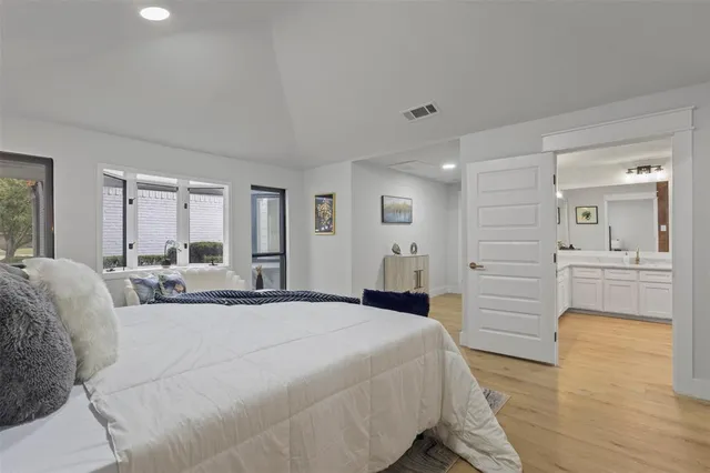 a large bedroom with a bed and a couch