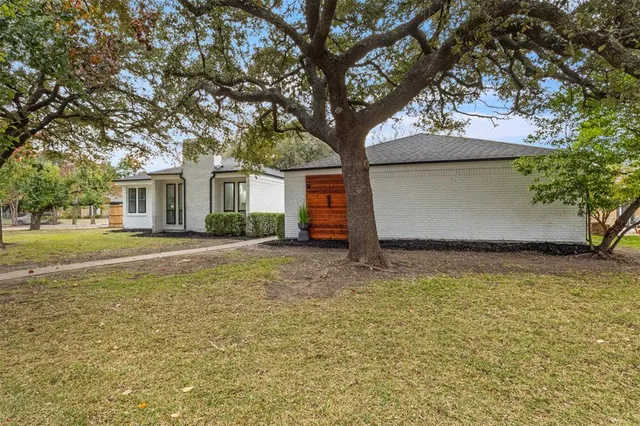 a house that has a tree in front of it