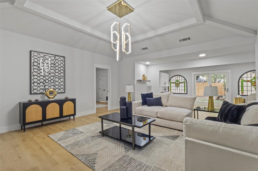 1 Spring Valley Court Richardson, TX 75081 - Photo 9 of 40 Living room featuring beamed ceiling, wood finished floors, recessed lighting, and a chandelier