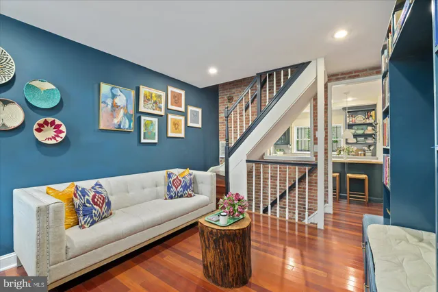 a living room with furniture and a book shelf