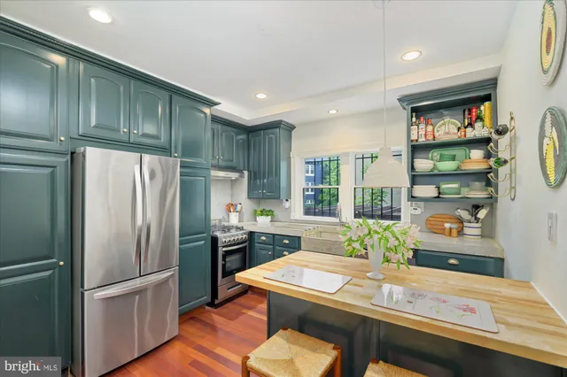 a kitchen with a sink cabinets and wooden floor