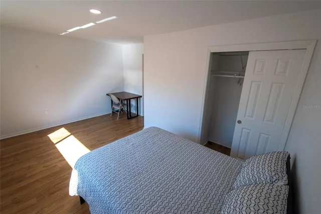 a view of walk in closet with wooden floor