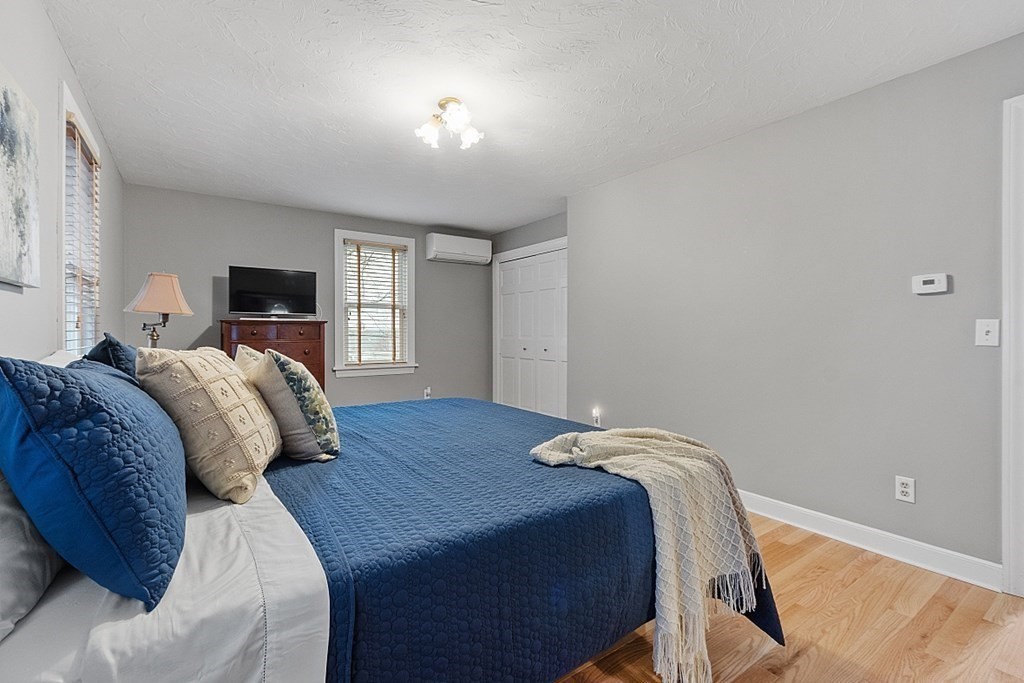 49 Central Tree Road Rutland, MA 01543 - Photo 17 of 42 a bedroom with a bed and wooden floor