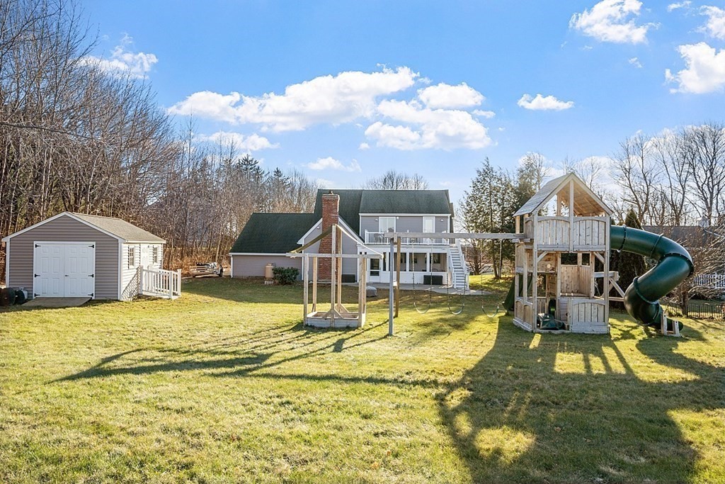49 Central Tree Road Rutland, MA 01543 - Photo 35 of 42 a house that has a big yard and couches chairs with wooden floor
