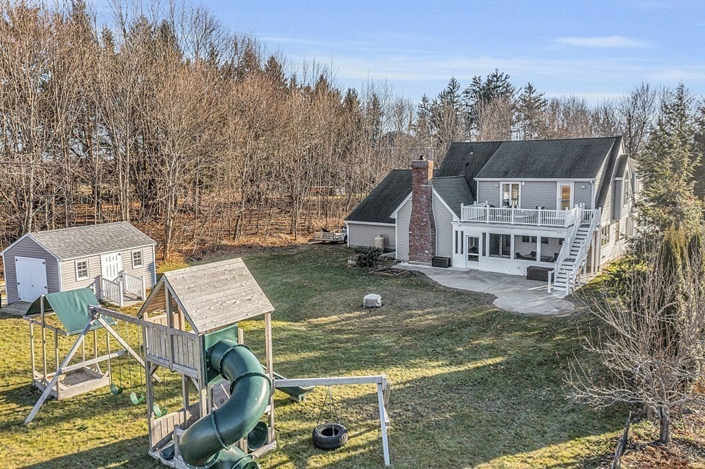 49 Central Tree Road Rutland, MA 01543 - Photo 36 of 42 aerial view of residential houses with yard and mountain view in back