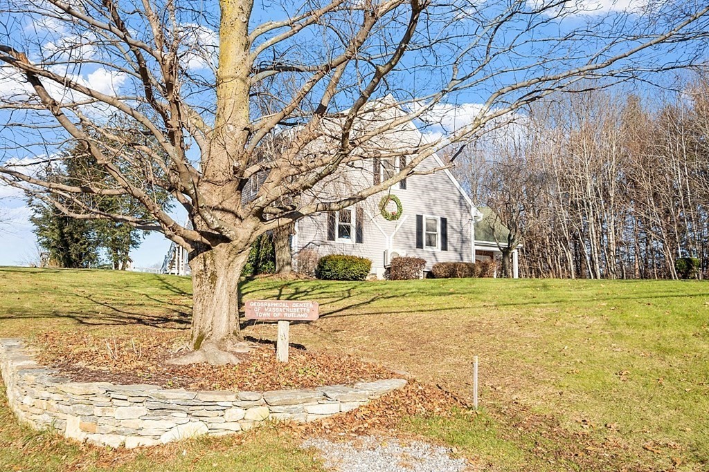 49 Central Tree Road Rutland, MA 01543 - Photo 39 of 42 a view of a yard in front of a house with a large tree