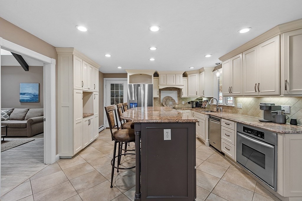 49 Central Tree Road Rutland, MA 01543 - Photo 6 of 42 a kitchen with kitchen island granite countertop wooden cabinets and stainless steel appliances
