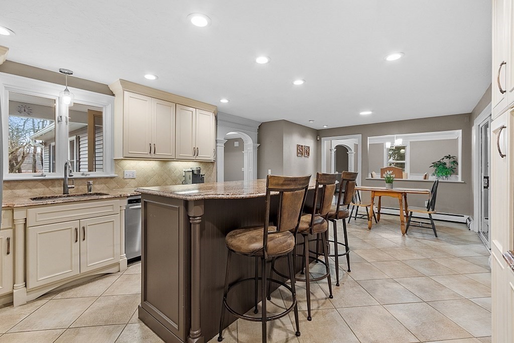 49 Central Tree Road Rutland, MA 01543 - Photo 9 of 42 a kitchen with stainless steel appliances granite countertop a table and chairs in it
