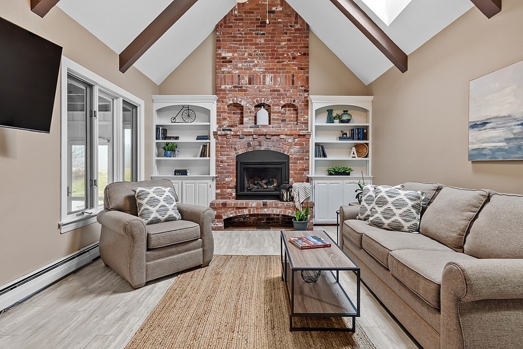 49 Central Tree Road Rutland, MA 01543 - Photo 10 of 42 a living room with furniture a flat screen tv and a fireplace