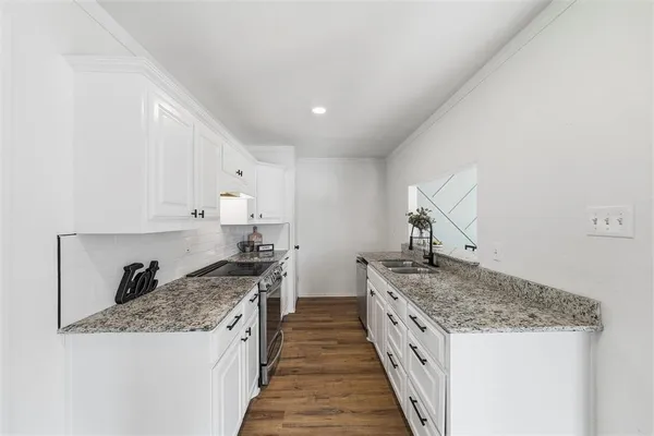 a kitchen with stainless steel appliances granite countertop a stove and a sink