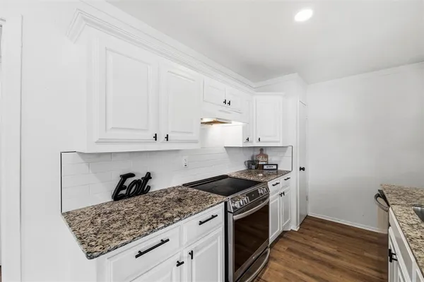 a kitchen with a stove and cabinets