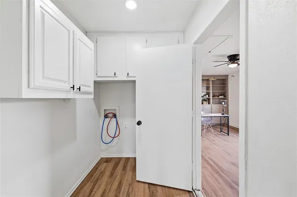 a room with wooden floor and cabinets