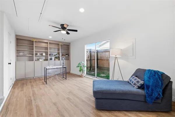 a living room with furniture and wooden floor