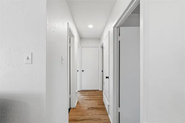 a view of hallway with wooden floor