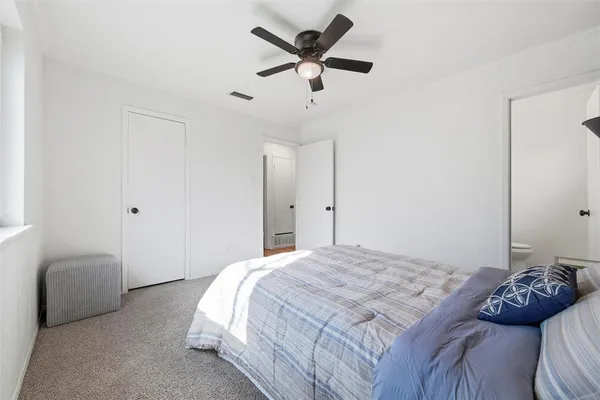 a bedroom with a bed and a couch