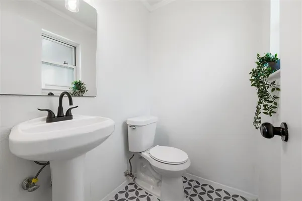 a bathroom with a sink toilet and mirror