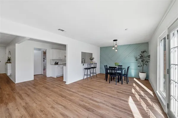 a view of a room with furniture and wooden floor