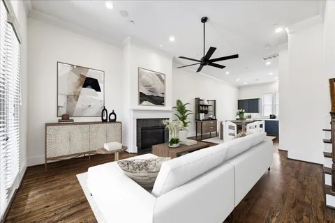 a living room with furniture a fireplace and kitchen view