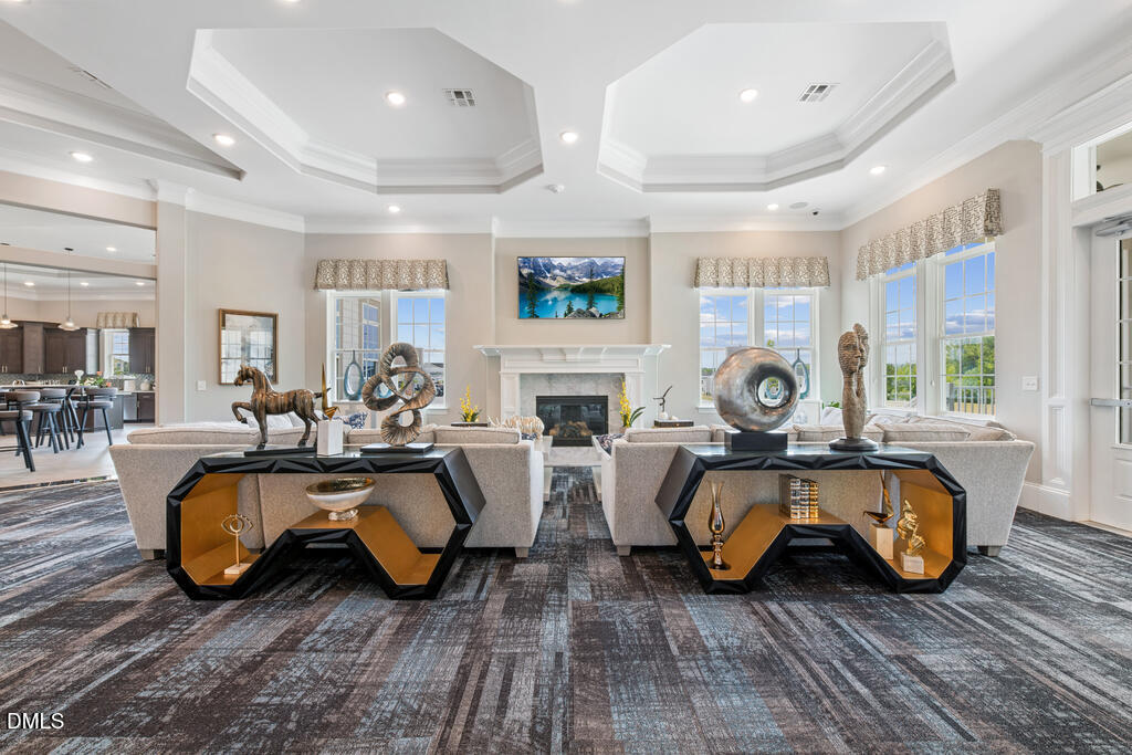 2032 Abbeyhill Drive, Unit 100 Raleigh, NC 27610 - Photo 5 of 7 a living room with furniture a fireplace and a table