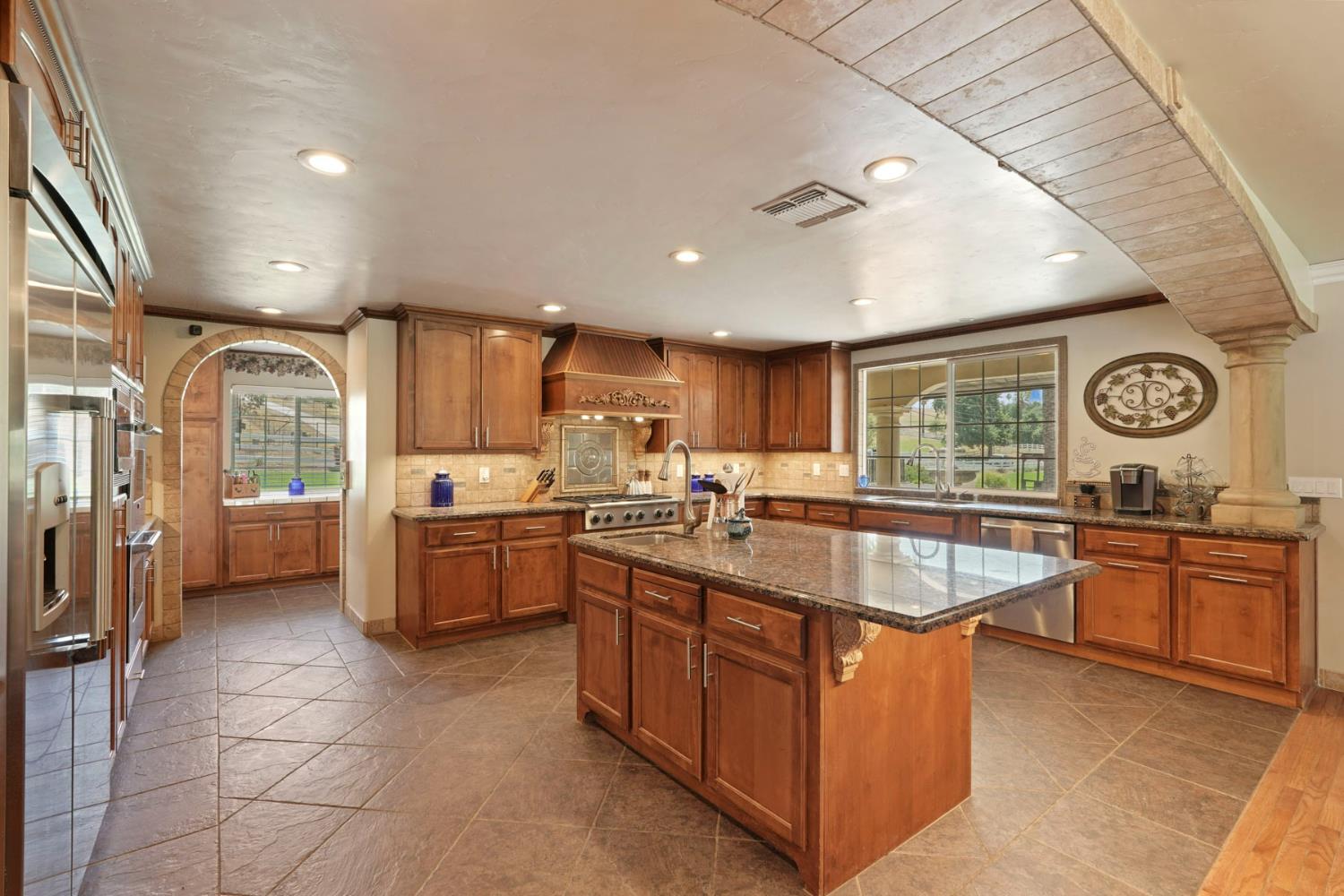 5407 Butler Road Penryn, CA 95663 - Photo 13 of 69 a large kitchen with kitchen island granite countertop a large counter top and stainless steel appliances