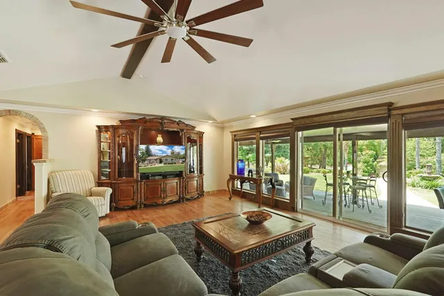 a living room with furniture and kitchen view