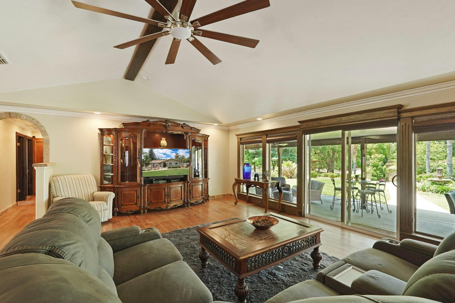 5407 Butler Road Penryn, CA 95663 - Photo 15 of 69 a living room with furniture a ceiling fan and a floor to ceiling window