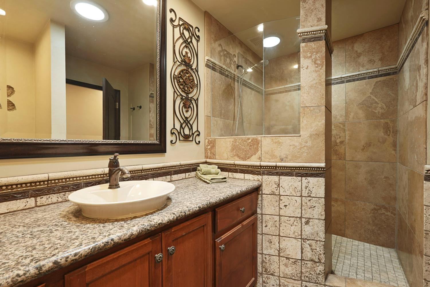 5407 Butler Road Penryn, CA 95663 - Photo 28 of 69 a bathroom with a granite countertop sink and a mirror