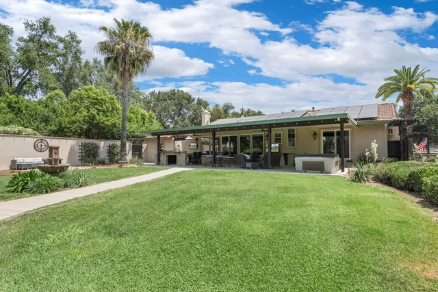 a bathroom with a granite countertop sink a toilet and a mirror