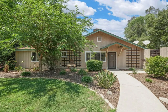 a view of a yard with wooden fence