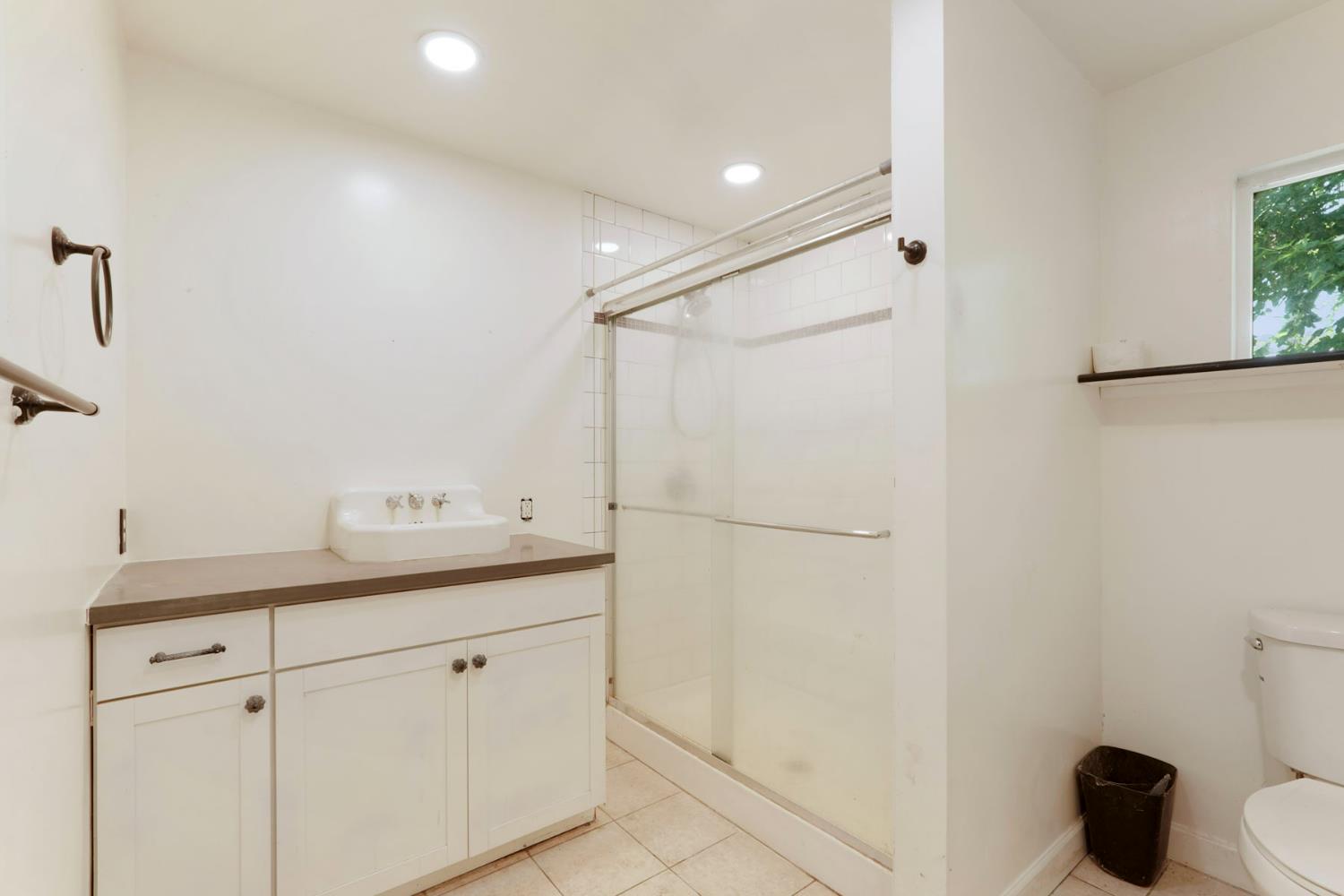 5407 Butler Road Penryn, CA 95663 - Photo 49 of 69 a bathroom with a granite countertop sink a toilet and a mirror