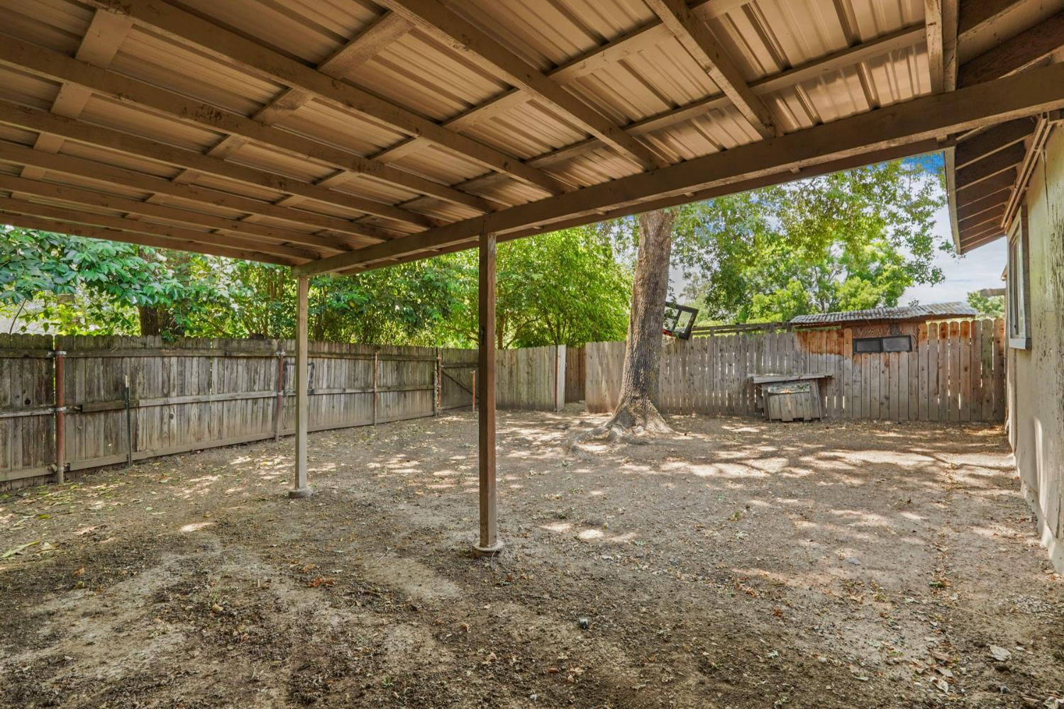 5407 Butler Road Penryn, CA 95663 - Photo 51 of 69 a view of a backyard with wooden fence and a tree