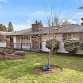 a view of a house with backyard porch and sitting area