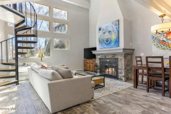 a living room with fireplace furniture and a window