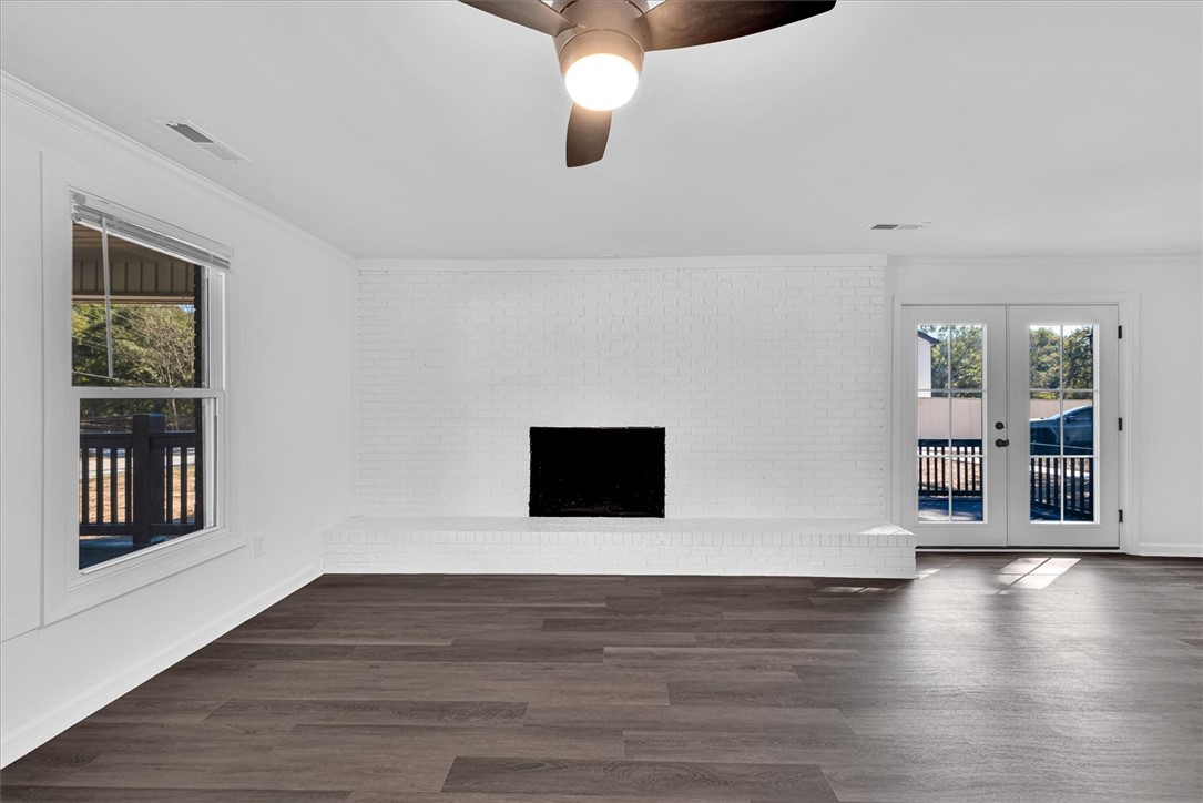 801 Cherokee Road Pelzer, SC 29669 - Photo 12 of 45 This bright living space features elegant flooring and a cozy fireplace, perfect for relaxation.