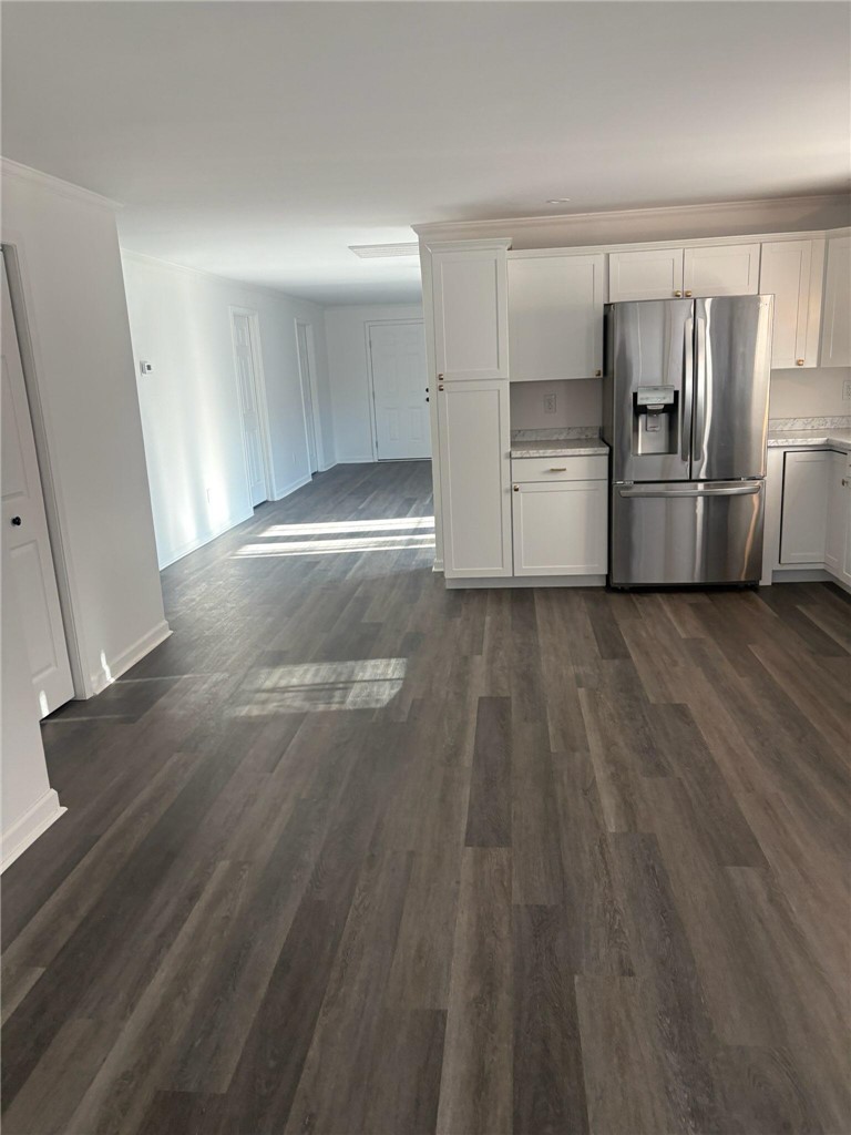 801 Cherokee Road Pelzer, SC 29669 - Photo 18 of 45 This bright, open-concept interior features modern flooring and a well-appointed kitchen.