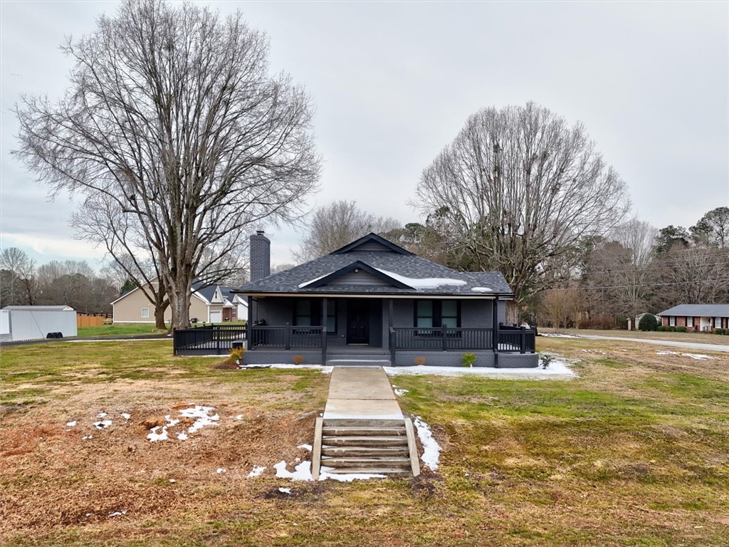 801 Cherokee Road Pelzer, SC 29669 - Photo 2 of 45 This charming residence features a well-maintained exterior and inviting front porch, set on a spacious lot.