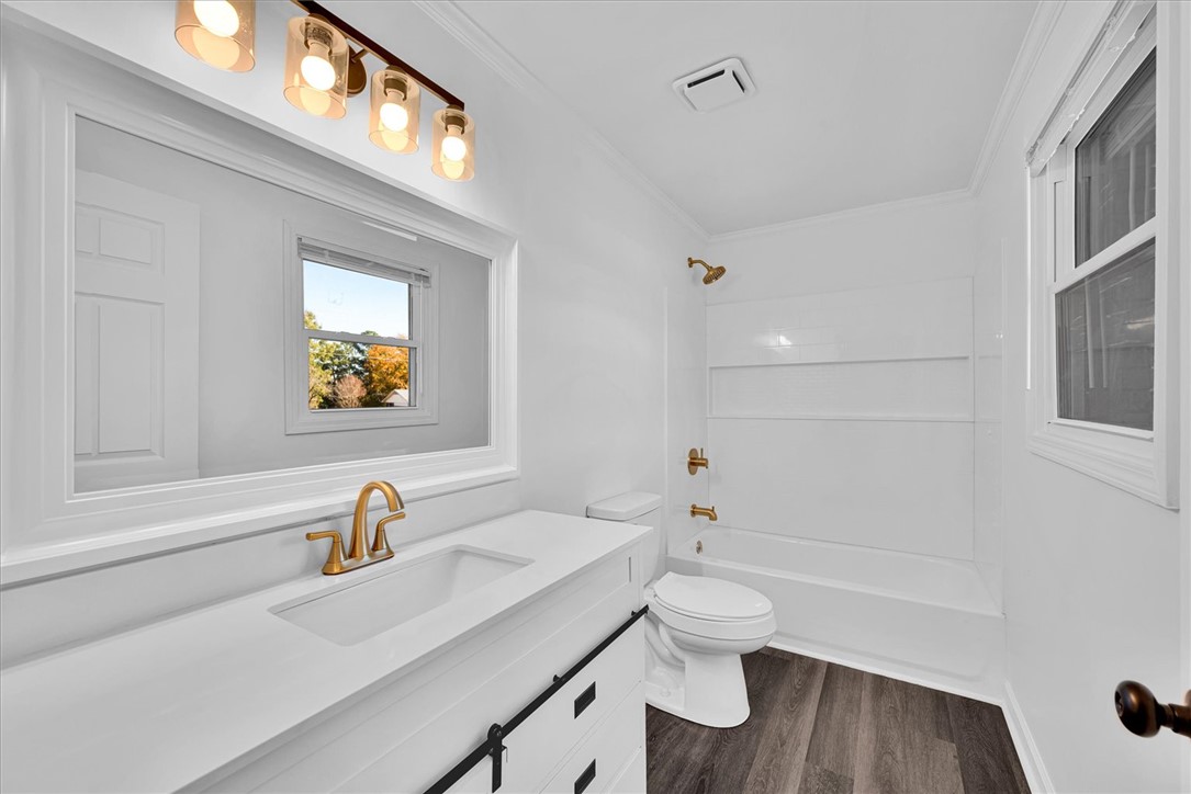 801 Cherokee Road Pelzer, SC 29669 - Photo 26 of 45 This bright bathroom features a clean vanity, modern fixtures, and a shower-over-tub combination.