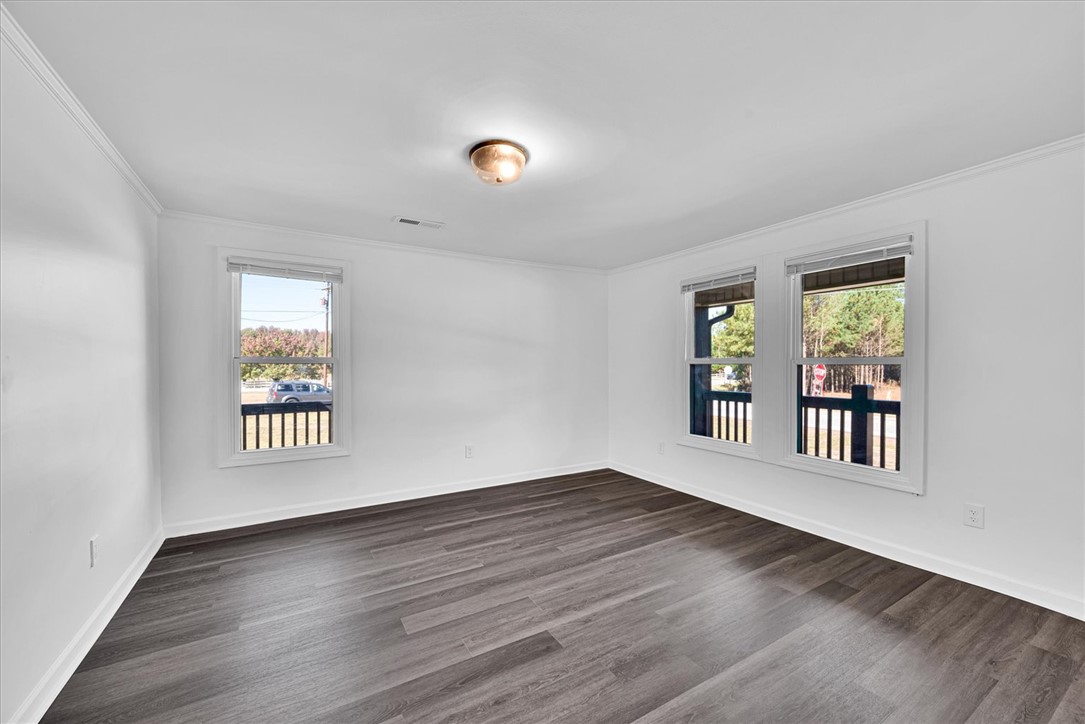 801 Cherokee Road Pelzer, SC 29669 - Photo 27 of 45 This bright room features durable flooring and multiple windows, creating a versatile living space.