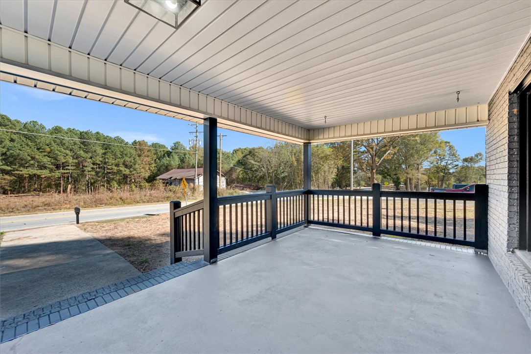 801 Cherokee Road Pelzer, SC 29669 - Photo 28 of 45 Enjoy peaceful moments on this inviting porch, offering a seamless blend of comfort and natural surroundings.