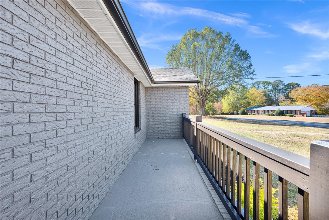 801 Cherokee Road Pelzer, SC 29669 - Photo 30 of 45 This residence features durable brick construction and a charming porch with railings.