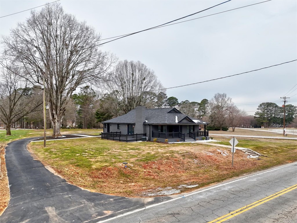 801 Cherokee Road Pelzer, SC 29669 - Photo 44 of 45 This charming residence features a well-maintained exterior with a inviting front porch and mature trees.