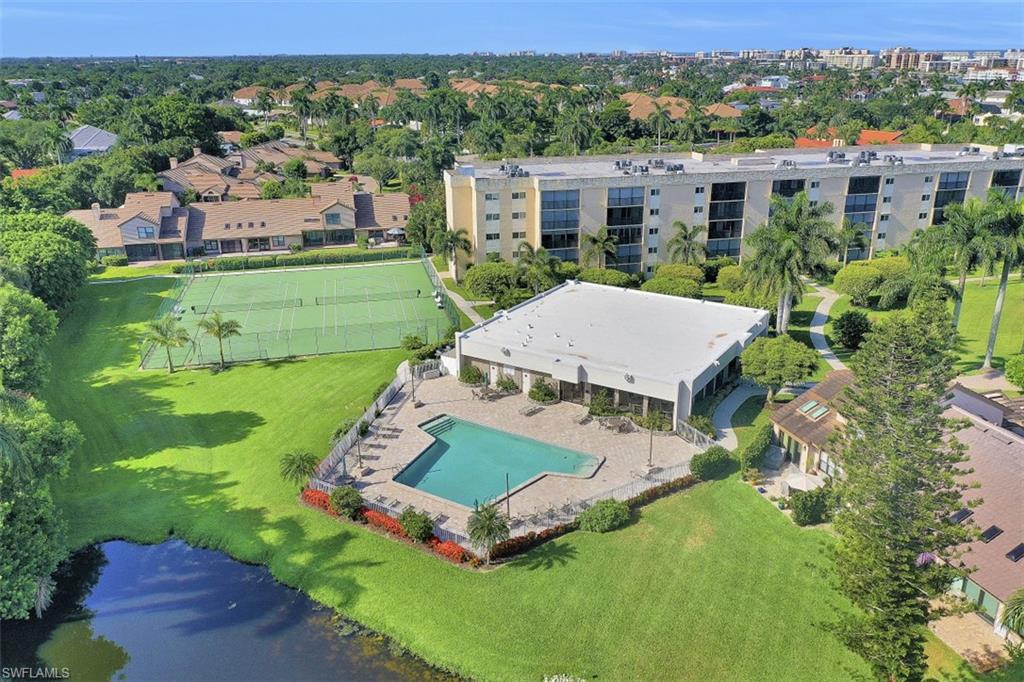 4004 Crayton Road Naples, FL 34103 - Photo 22 of 29 Community center, community pool and tennis courts.