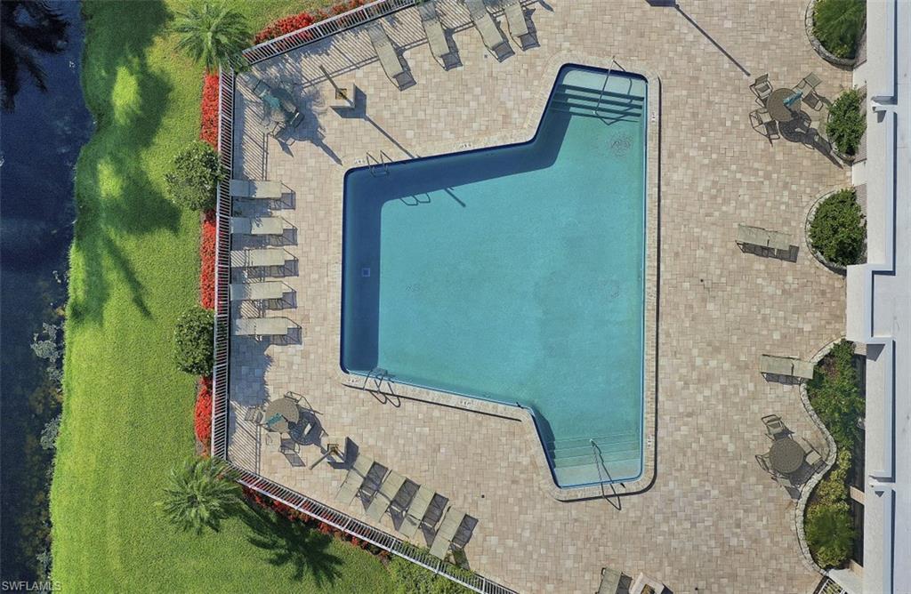 4004 Crayton Road Naples, FL 34103 - Photo 23 of 29 Large community pool with plenty of relaxing lounge chairs and space.